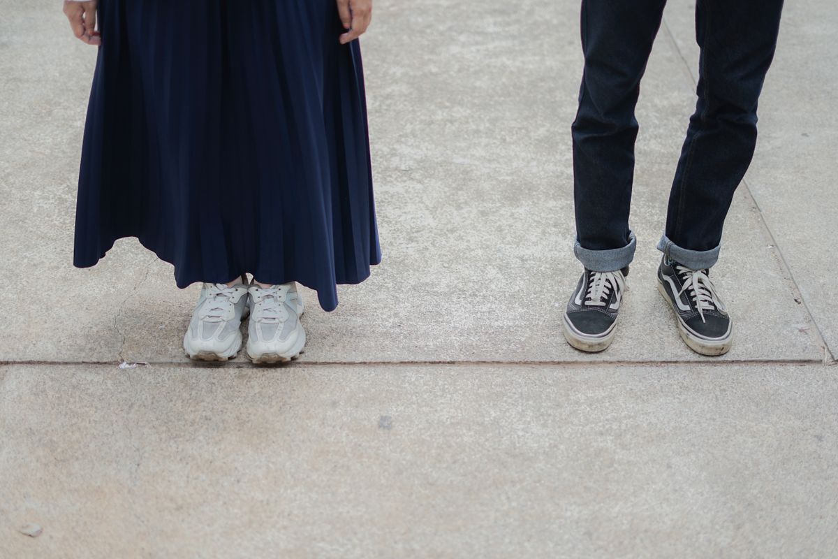 Two people standing together in sneakers