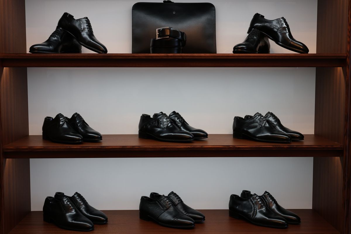 Black leather dress shoes displayed on shop shelves