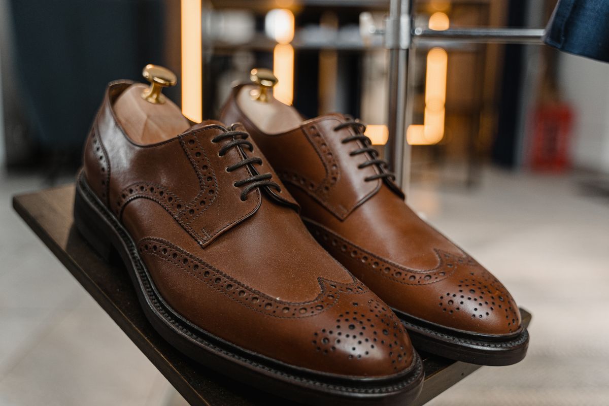 Brown leather brogues with wooden shoe trees inside