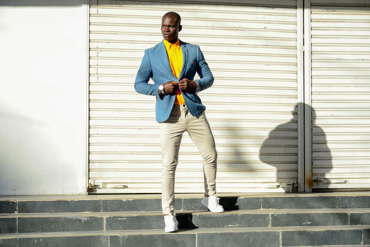 Man wearing a blazer and chinos with white sneakers