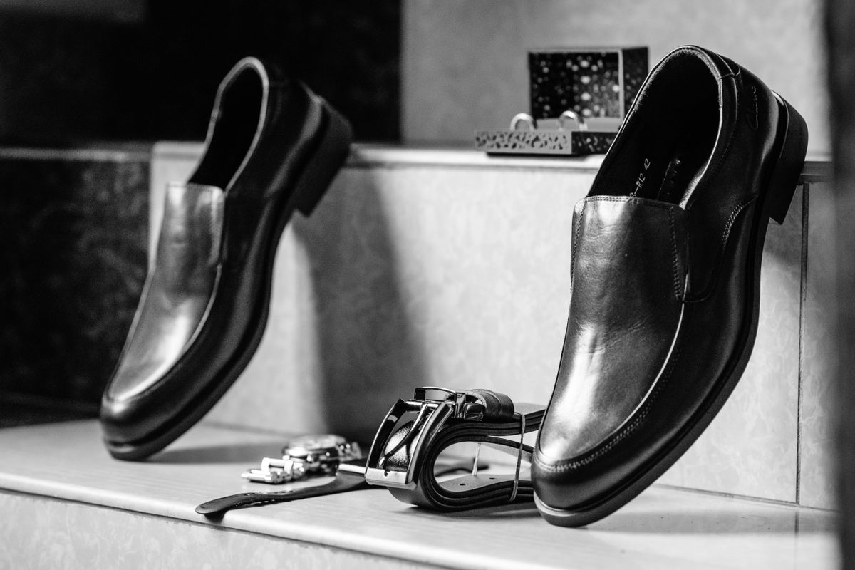 Black monk strap shoes photographed on stone steps