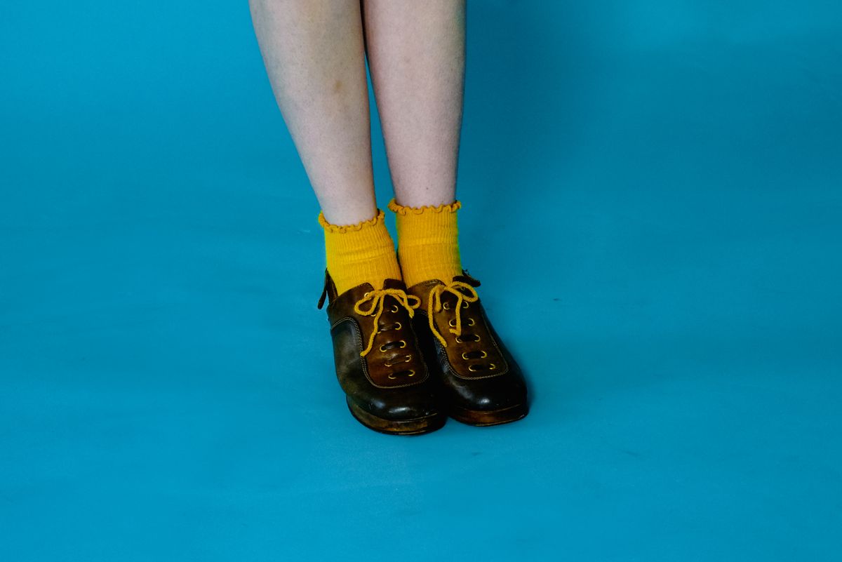 Yellow socks worn with patent brogues